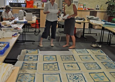 Mary H. discussing the layout with Sue